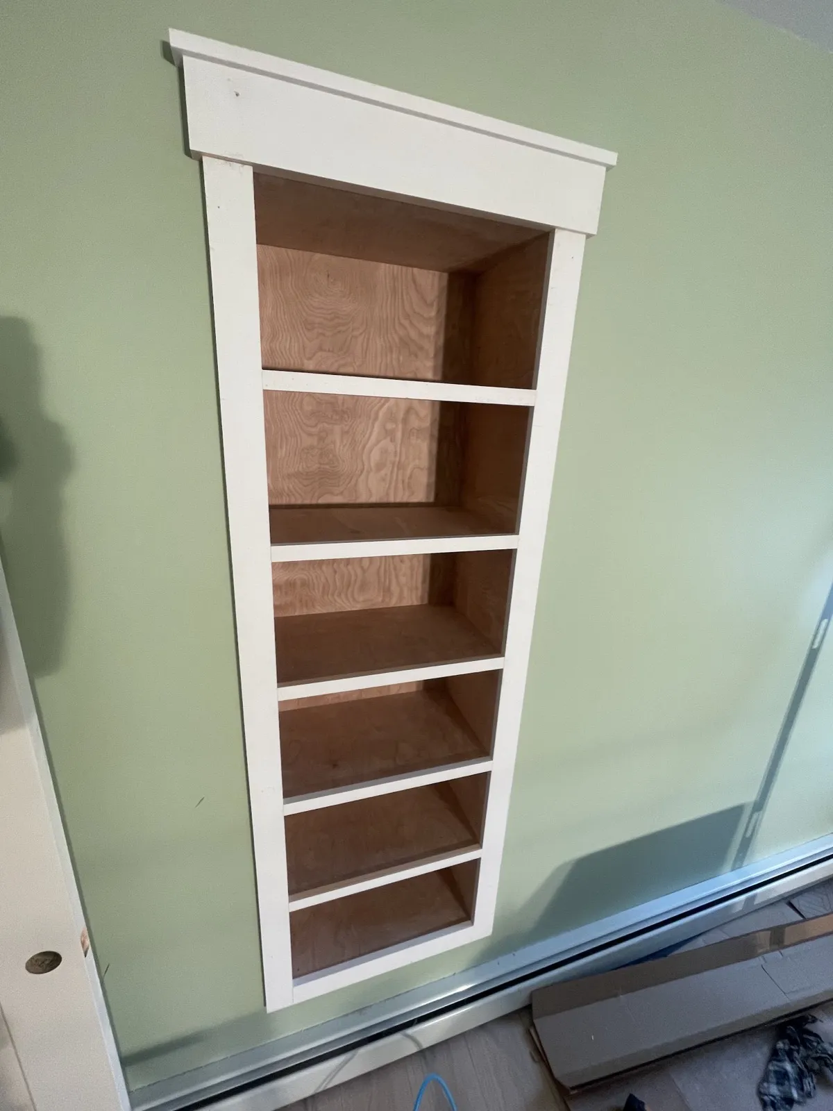 Built-in bookshelves matched to craftsman trim in a Lewiston, Maine bedroom