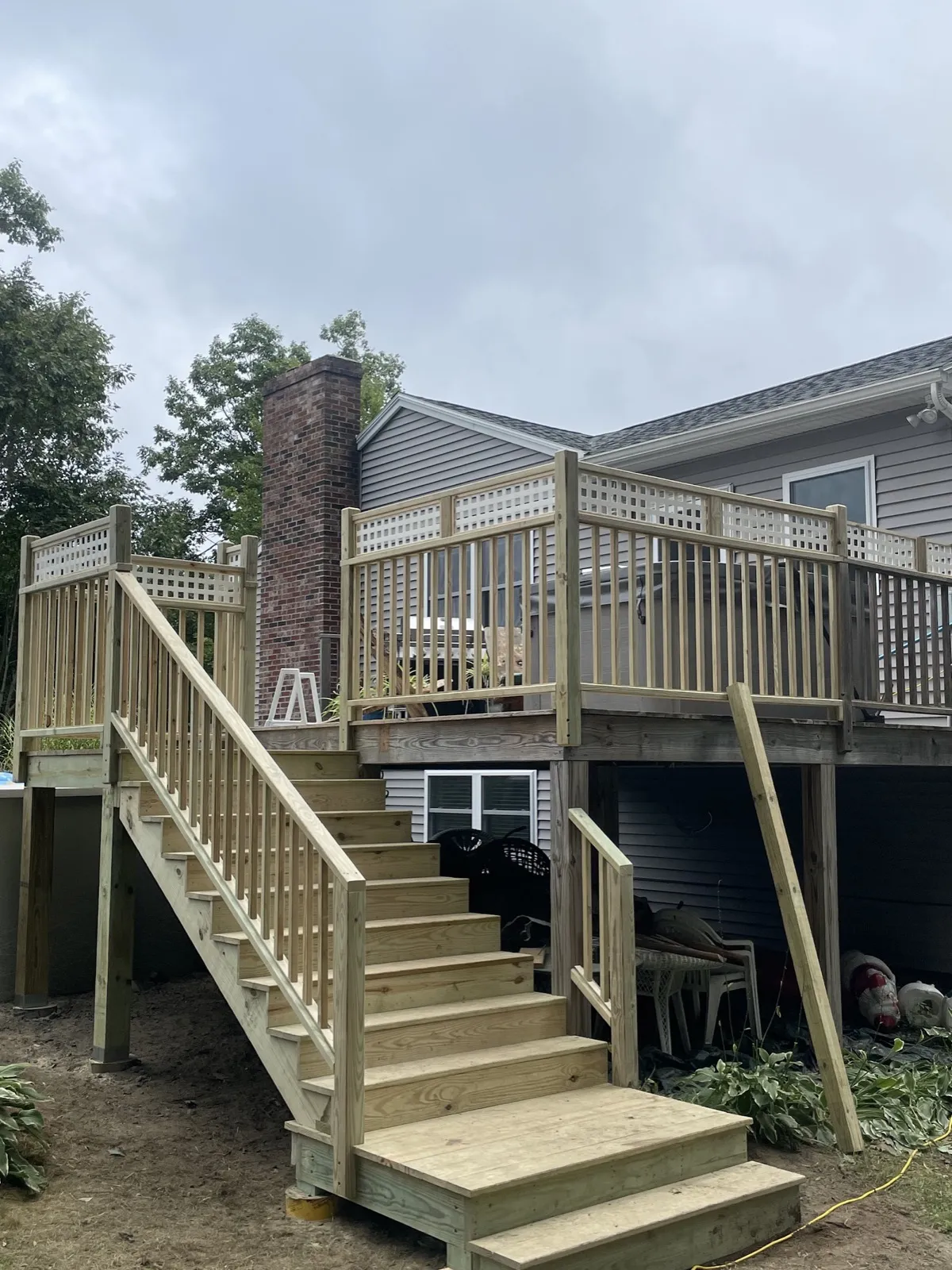 Extra-wide stairs from a hot tub deck to the yard in Arundel, Maine