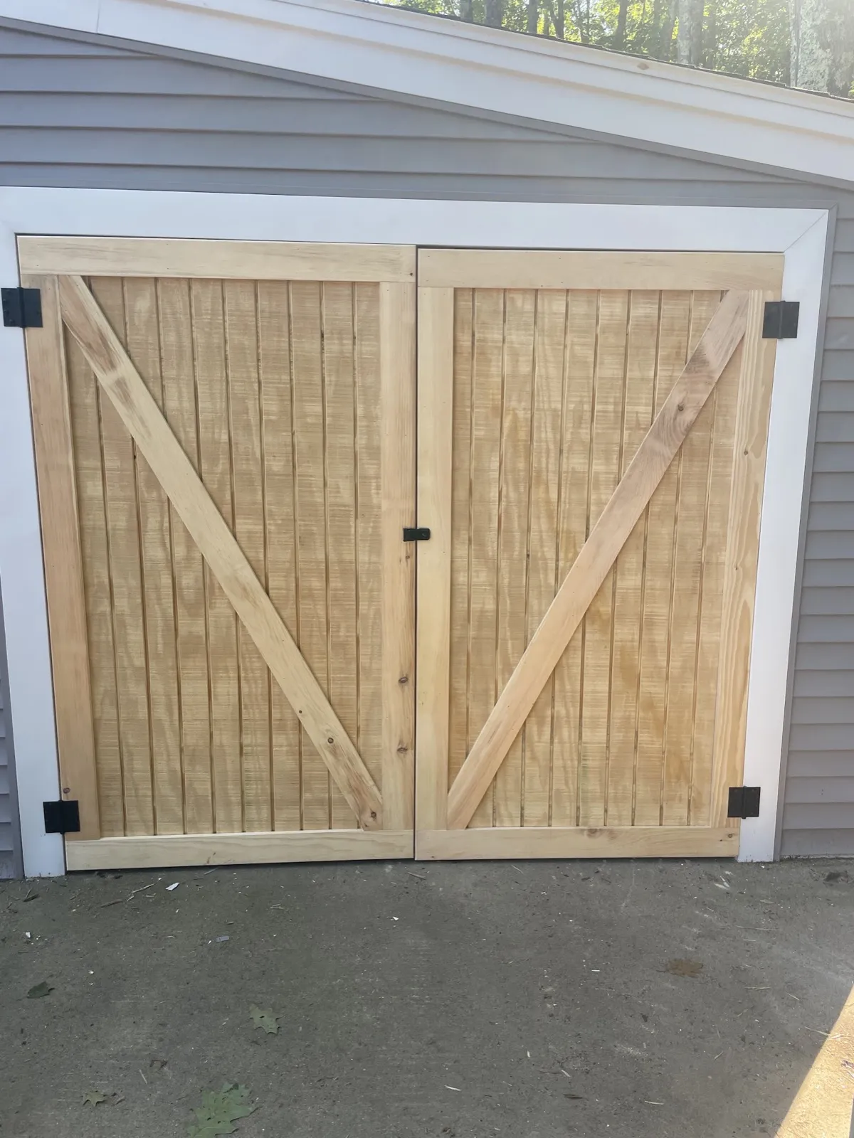 Barn doors on a lean-to for lawn equipment in Arundel, Maine