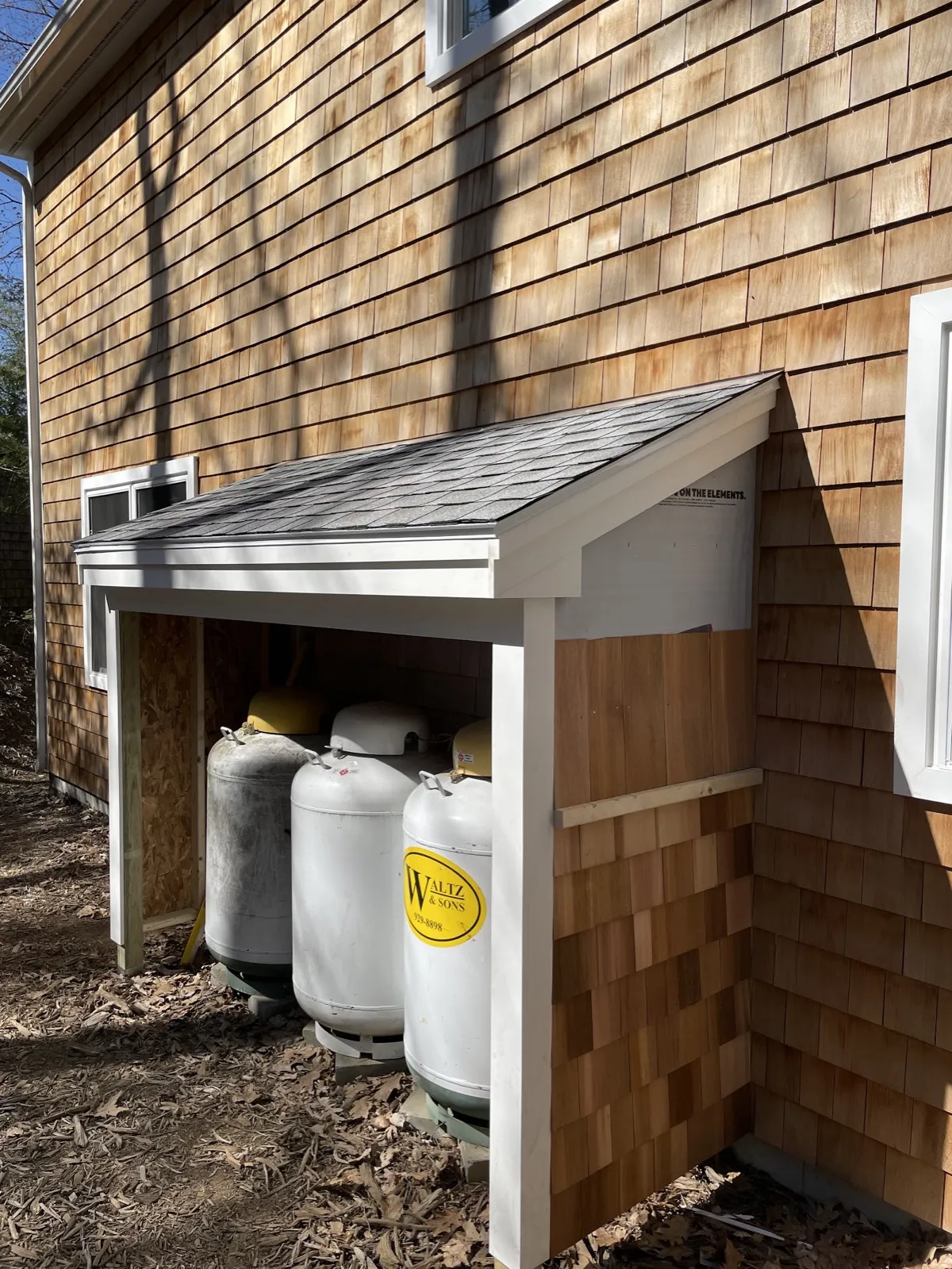 Propane tank enclosure matching the siding in Lyman, Maine